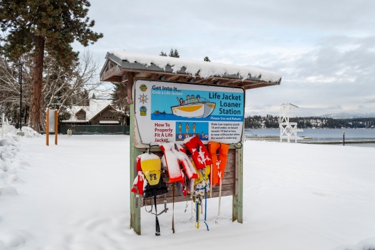 Hayden Lake, Idaho, USA - January 14 2019: The life jacket loaner station covered in snow during winter at Honeysuckle Beach on Hayden Lake.