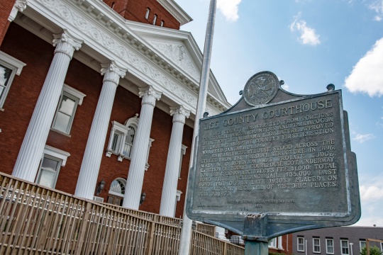 Opelika, Alabama/USA- May 10, 2019: Historic marker in front of the Lee County Courthouse shot at a dutch tilt.
