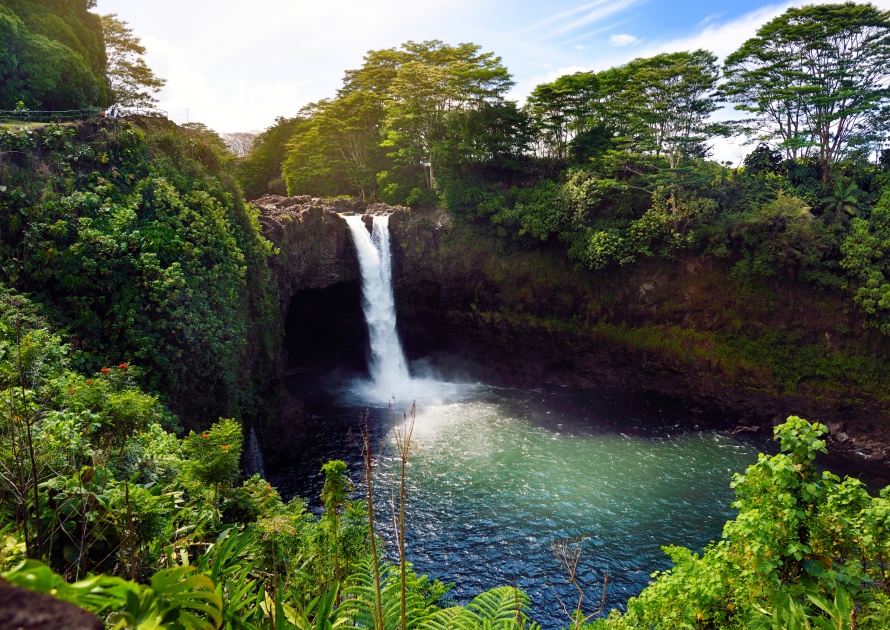 Majesitc Rainbow Falls waterfall in Hilo, Wailuku River State Park, Hawaii. The falls flows over a natural lava cave, the mythological home to Hina, an ancient Hawaiian goddess.
