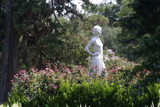 PONCA CITY, OKLAHOMA— Wide shot of the statue of Lydie Marland at the garden of Marland Mansion in Ponca City. Marland Mansion is one the top attractions in Oklahoma. Photo taken in August 2015.