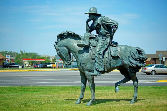 Lander Wyoming July 17, 2017 Statue of Cowboy resting on his horse