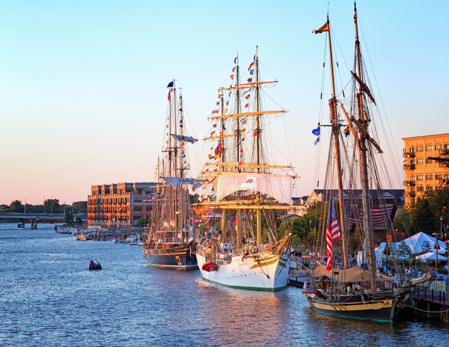 BAY CITY, MICHIGAN-JULY 11, 2013: Tall Ships line the river's edge at Wenonah Park at sunset for the Tall Ship Celebration