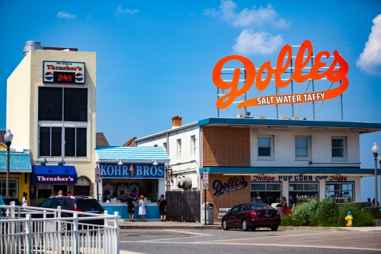 Rehoboth Beach, DE - June 25, 2013: The big orange Dolles Salt Water Taffy sign on top of the candy shop has become a Delaware landmark.