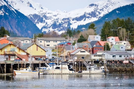 Sitka, Alaska / USA - April 22, 2013: View Of Sitka Alaska Boats and Buildings from the Water with Mountain Background