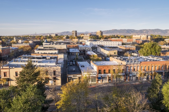 aerial view of Fort Collins downtown in sunrise light, shot from a low flying drone