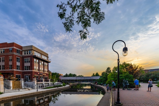 NAPERVILLE, IL, USA - JULY 14, 2018: Downtown Naperville Riverwalk on a busy Saturday night features plenty of restaurants, bars, art, entertainment, and architecture.