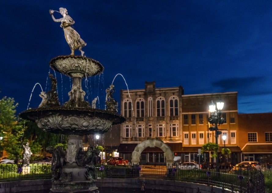 Bowling Green, Kentucky, USA - June 22, 2017: The fountain in the town square in historic downtown Bowling Green during blue hour.