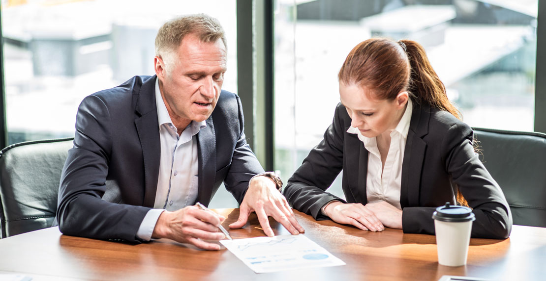 Man and woman going over real estate contract