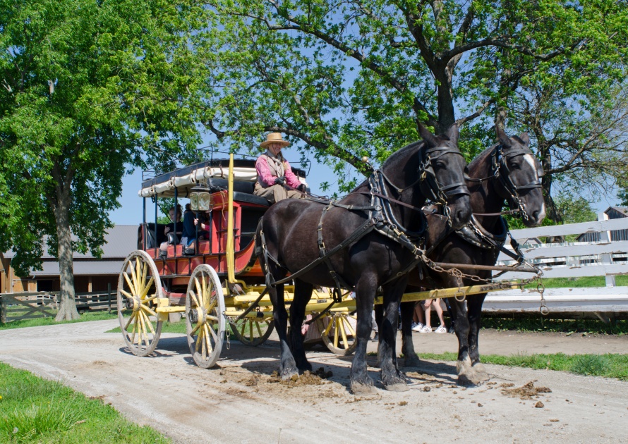 Olathe, Kansas /USA- May 14, 2019: Children enjoy a stagecoach ride around the Mahaffie Stagecoach and Farm Historic Site in Olathe, Kansas - an original stop along the California & Oregon Trails.