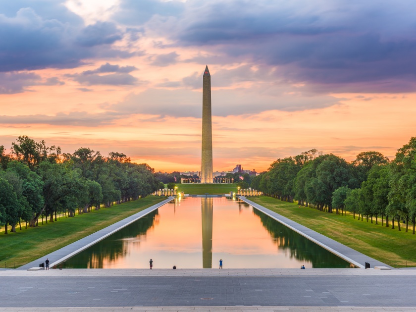 Washington Monument at the Reflecting Pool in Washington, DC, USA at sunrise.