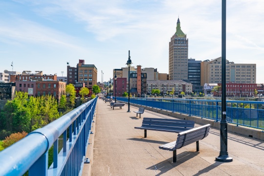ROCHESTER, NY - MAY 14, 2018: Skyline of Rochester, New York along the Pont De Rennes Pedestrian Bridge which is part of the Genesee Riverway Trail