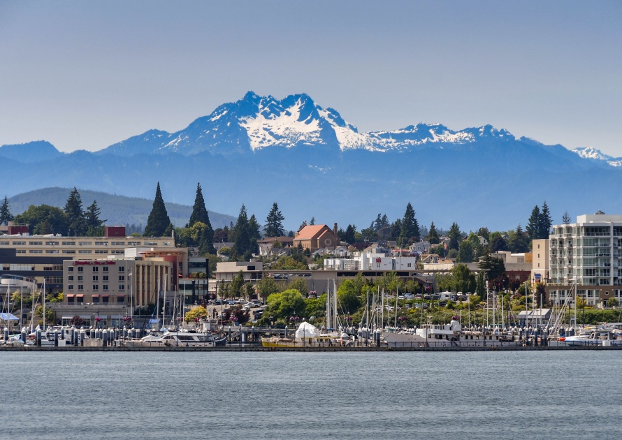 BREMERTON, WASHINGTON STATE, USA - JUNE 2018: Wide angle view of the marina and waterfront in Bremerton, WA, with a backdrop of snow cappped mountains.